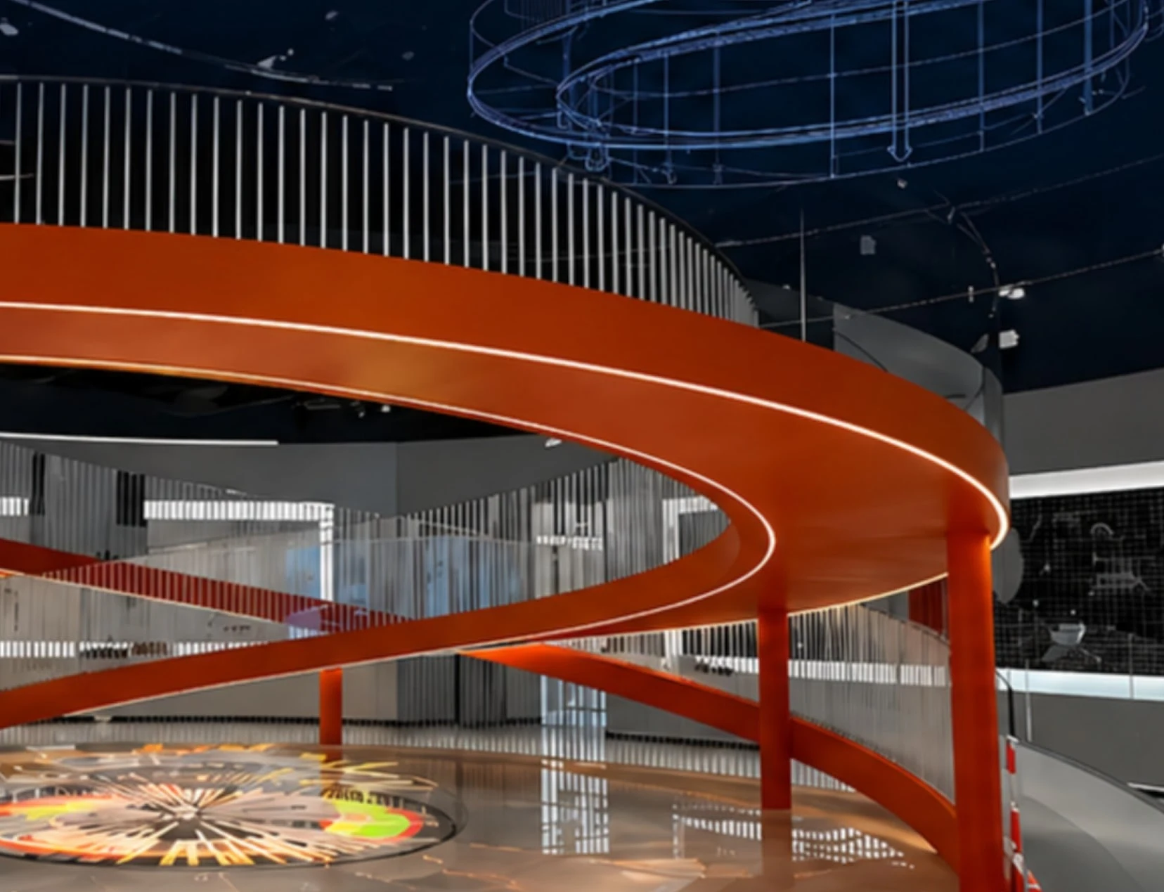 Closer view of the orange-red curved steel staircase and vertical balustrade in the Hualing showroom.